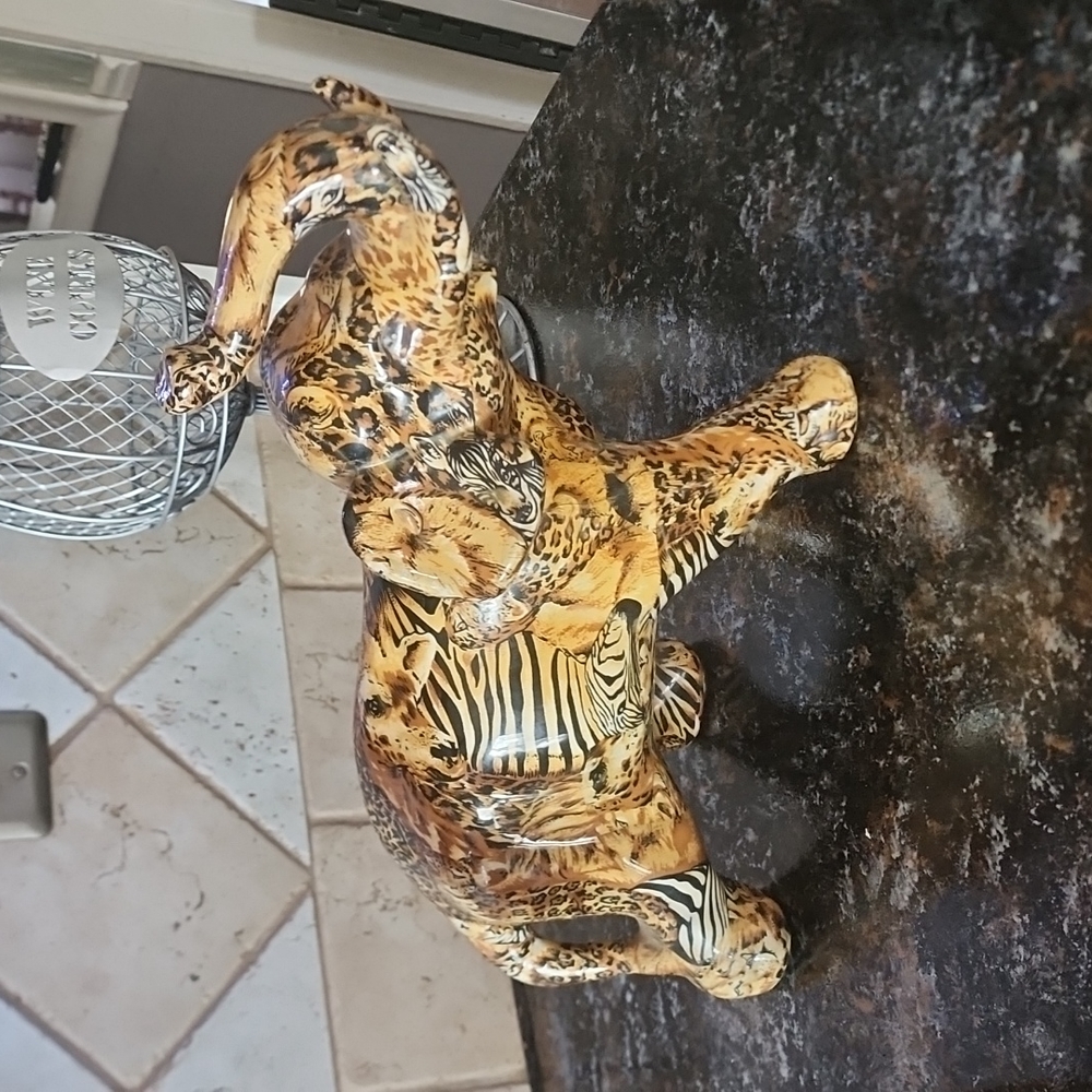 Blown ceramic elephant 🐘 gold brown black white in colors zebra leopard design.
